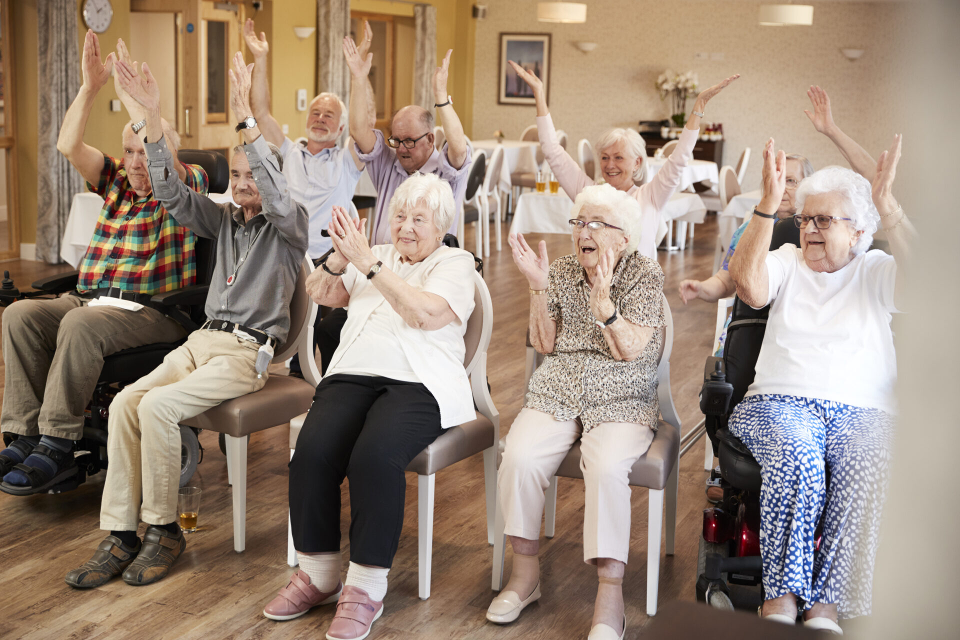 A group of older people clapping and cheering