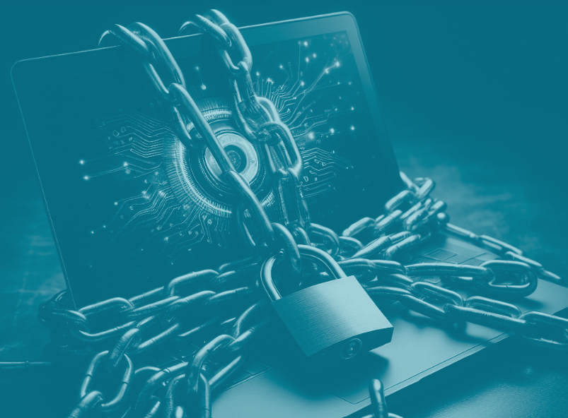 Delwedd o liniadur gyda chadwyni a chlo wedi'i lapio o'i gwmpas. // Image of a laptop with chains and a padlock wrapped around it.